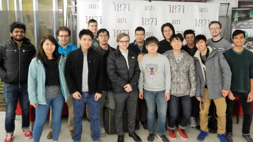 group posted photo in front of 1871 sign