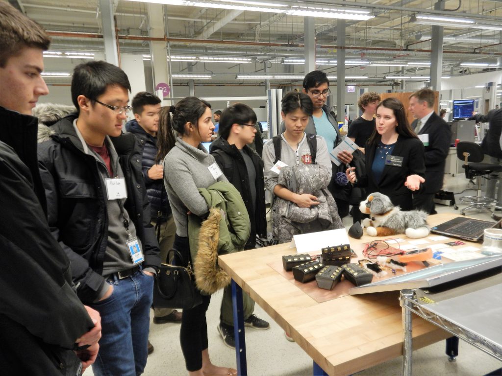 students looking at a product demonstration